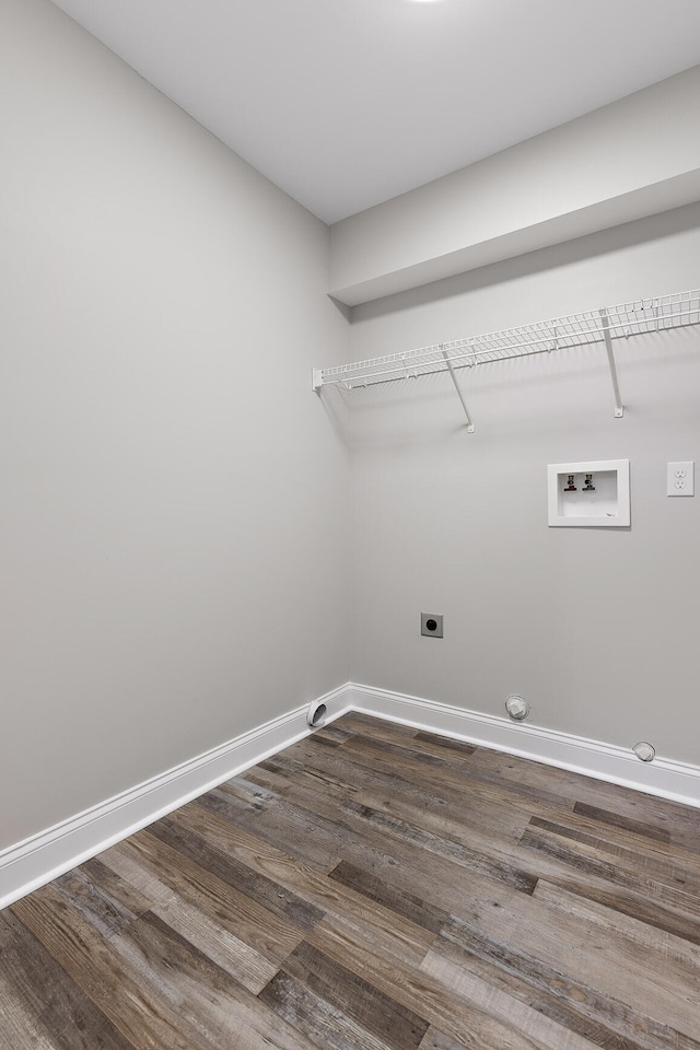 washroom with hookup for a washing machine, electric dryer hookup, dark hardwood / wood-style flooring, and gas dryer hookup