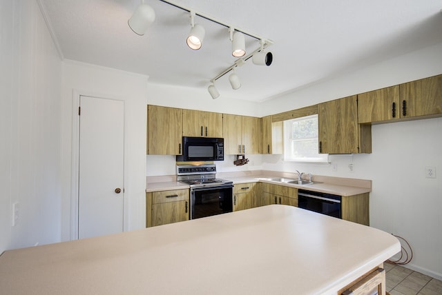 kitchen featuring rail lighting, ornamental molding, sink, black appliances, and light tile patterned floors