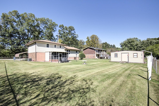 view of yard with a storage unit and a sunroom