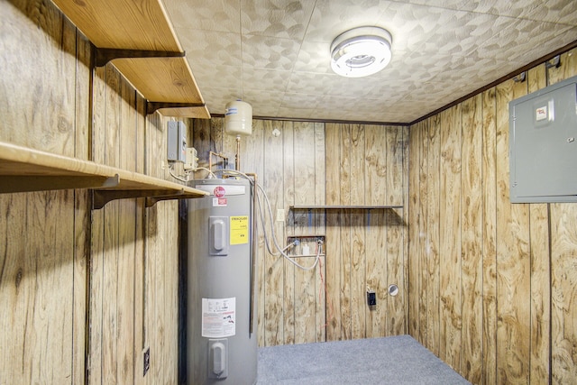 utility room featuring electric panel and water heater