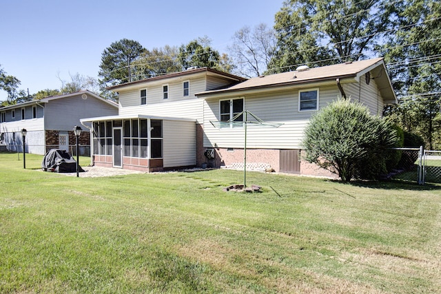 back of house featuring a sunroom and a yard