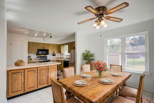 tiled dining room featuring ceiling fan