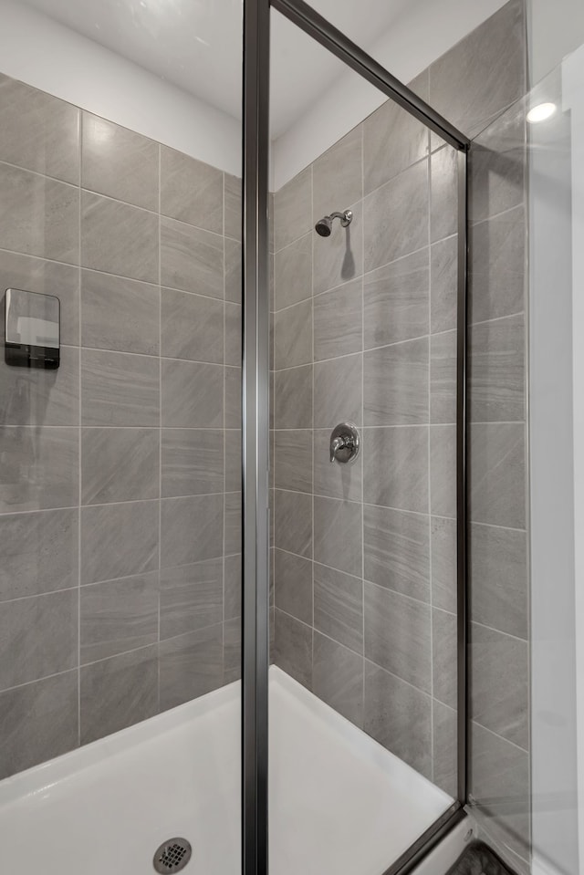 bathroom with a shower with door