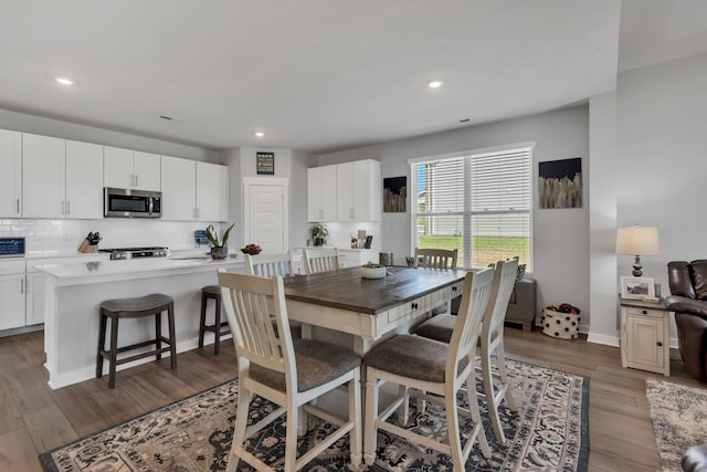 dining space with dark wood-type flooring