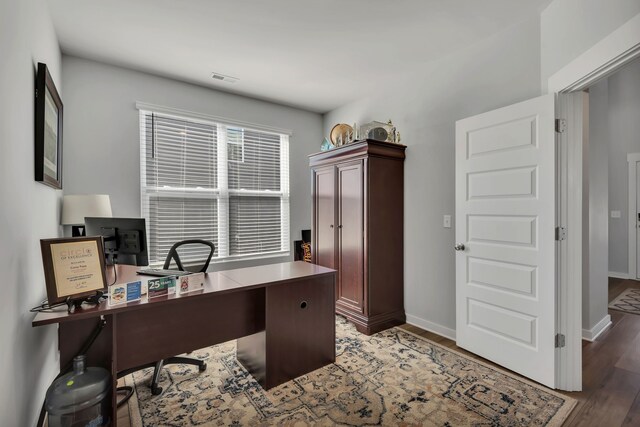 office space with dark wood-type flooring