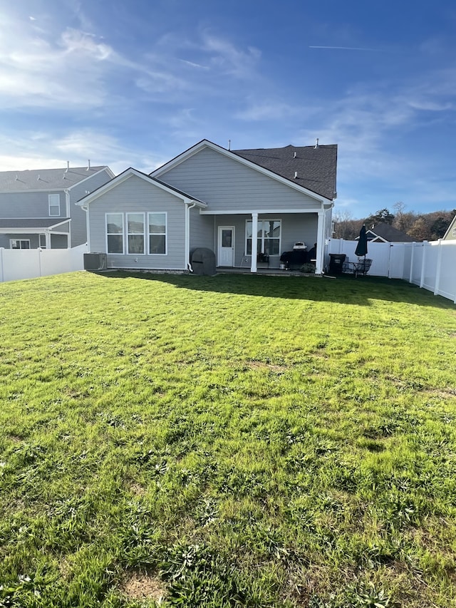 back of house featuring a yard