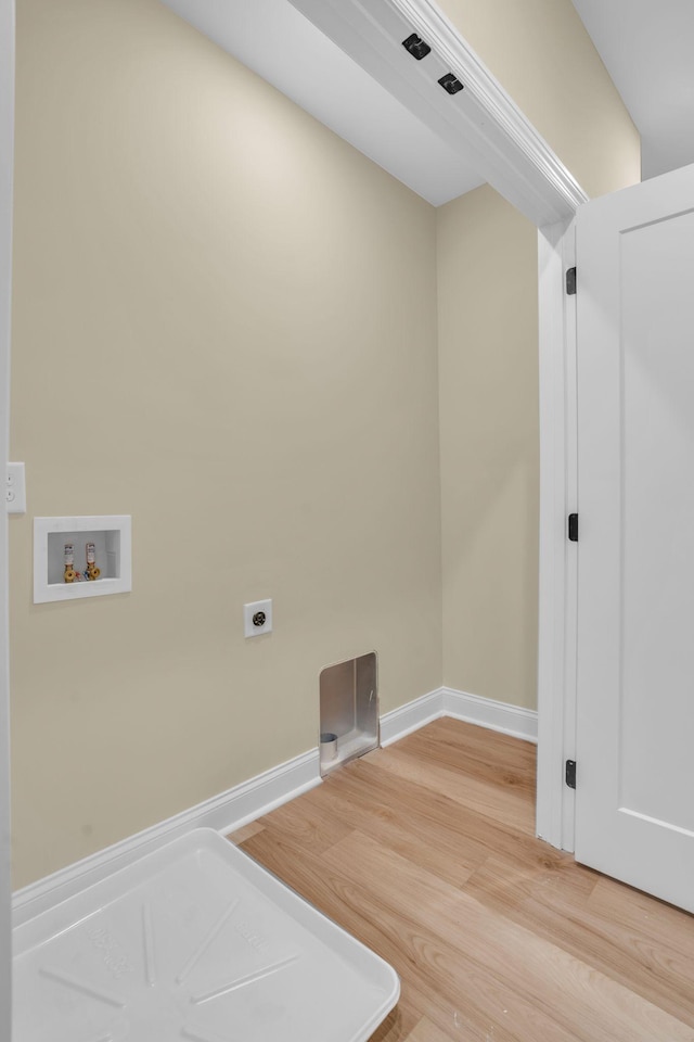 clothes washing area with hookup for an electric dryer, wood-type flooring, and washer hookup