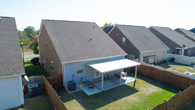 rear view of property with a patio, central AC, and a lawn