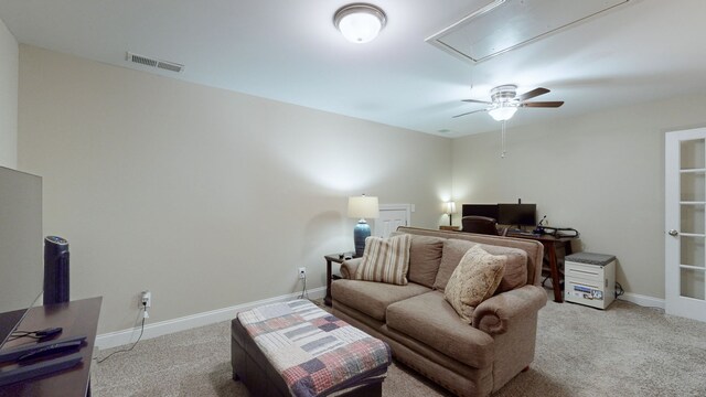 carpeted living room with ceiling fan