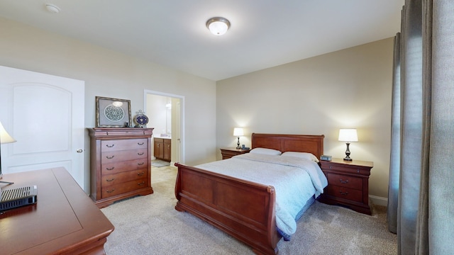 carpeted bedroom featuring ensuite bath