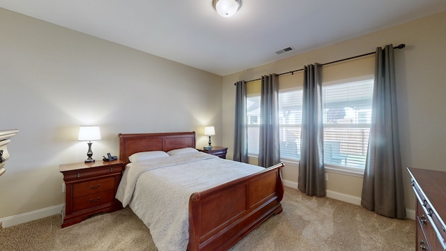 bedroom featuring light colored carpet