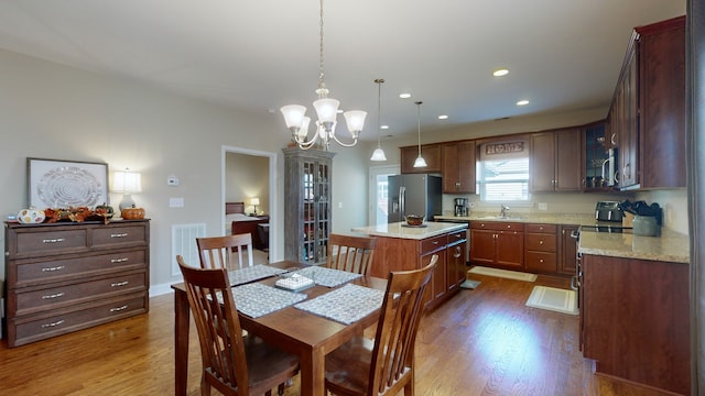 dining room with sink, a notable chandelier, and dark hardwood / wood-style flooring