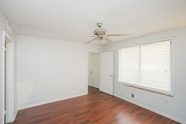 unfurnished room with dark wood-type flooring and ceiling fan