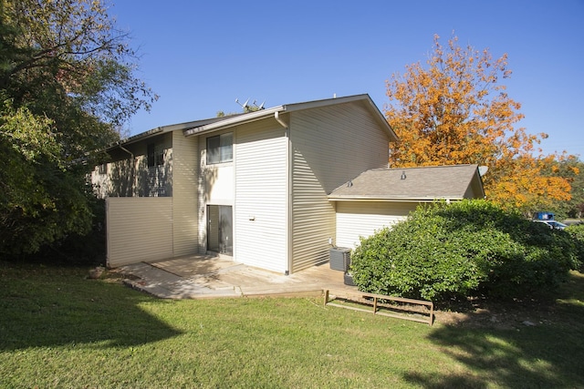 rear view of house with a yard and a patio