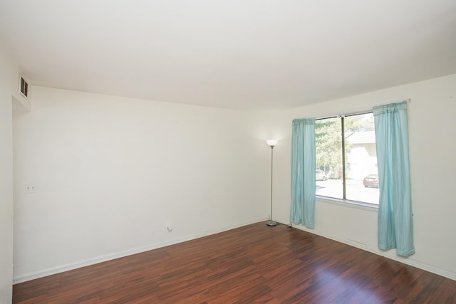 empty room with dark wood-type flooring