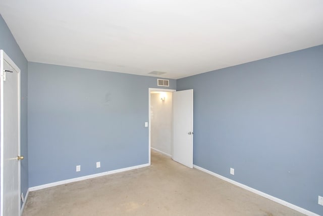 empty room featuring light carpet