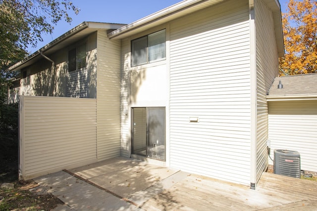 back of house featuring central AC, a patio, and a wooden deck