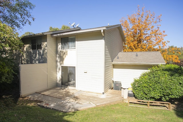 rear view of property featuring central air condition unit, a patio area, and a yard