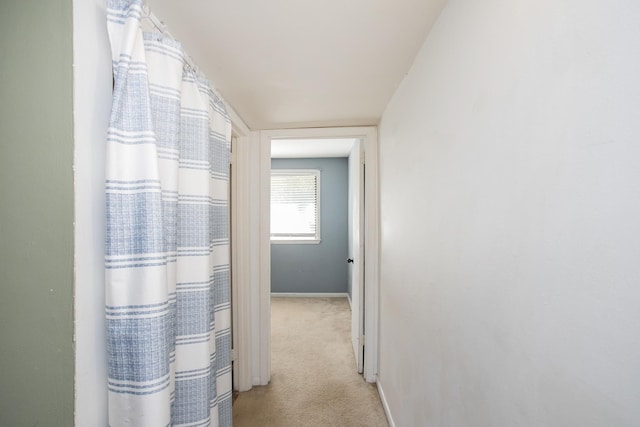 hall with light carpet and vaulted ceiling