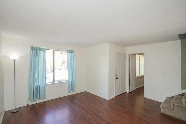 empty room with dark hardwood / wood-style floors