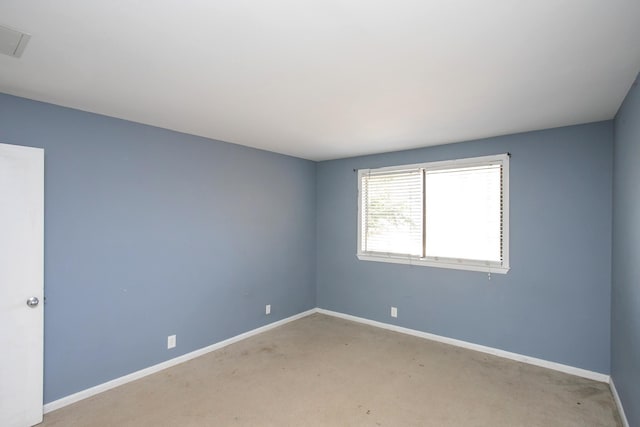 empty room featuring light carpet