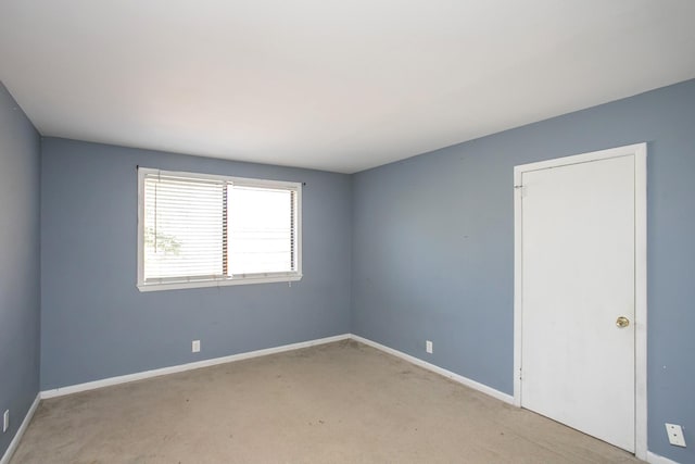 spare room with light colored carpet