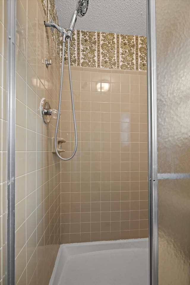 bathroom featuring a shower with door