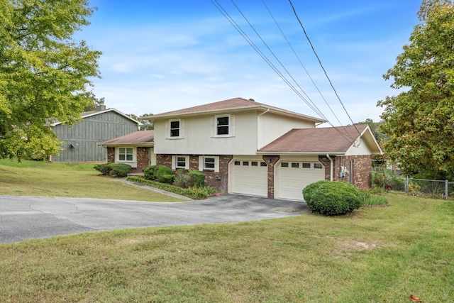 view of front of home with a front yard and a garage