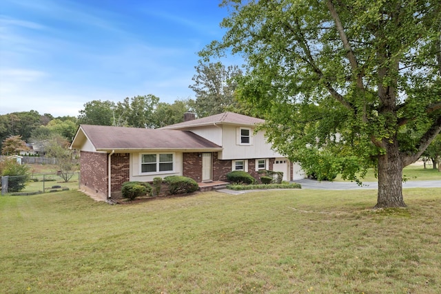 split level home featuring a front yard and a garage