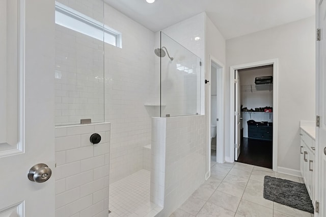 bathroom with vanity, tile patterned floors, and tiled shower