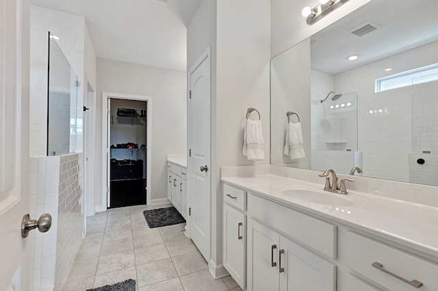 bathroom with vanity, tile patterned floors, and tiled shower