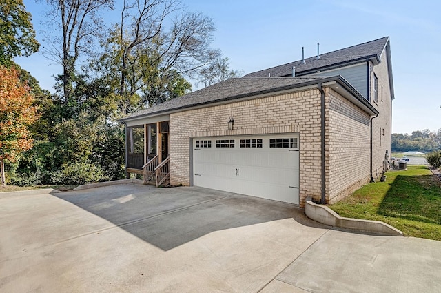 view of home's exterior featuring a yard and a garage