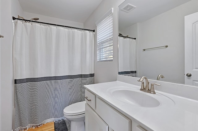 bathroom with toilet and vanity