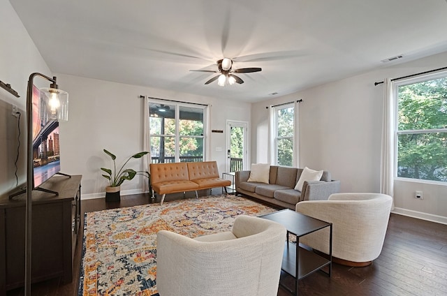 living room with ceiling fan and dark hardwood / wood-style flooring