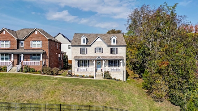 view of front of home featuring a front lawn and covered porch