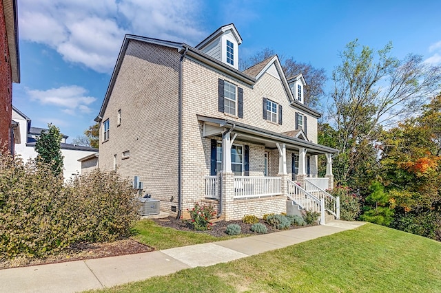 view of front facade with central AC, a front yard, and a porch