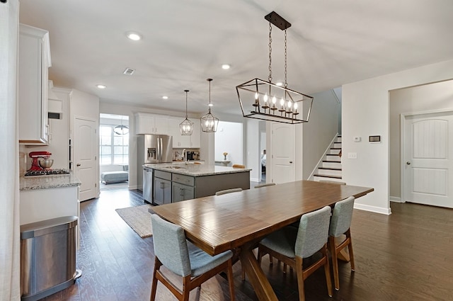 dining area with sink and dark hardwood / wood-style flooring