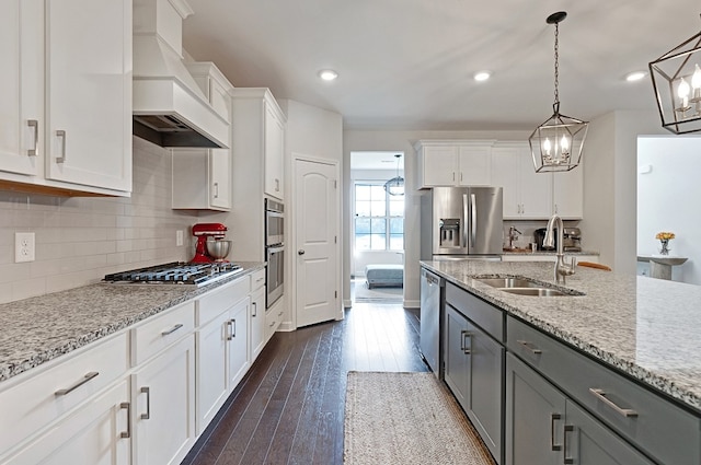 kitchen with gray cabinetry, sink, custom exhaust hood, and white cabinets