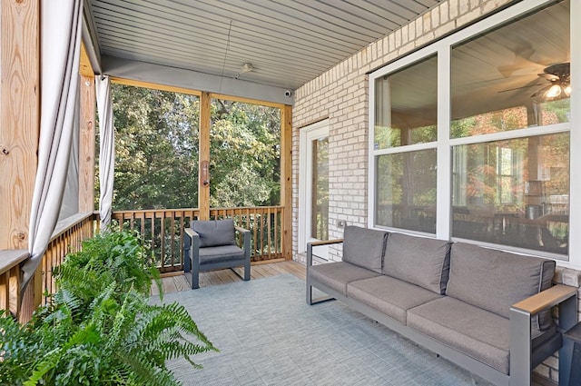 sunroom with ceiling fan and wooden ceiling