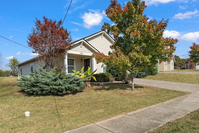 obstructed view of property with a front lawn