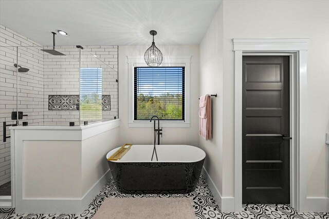 1878 Ferry Hill Rd, Dandridge, TN 37725 - bathroom with baseboards, tiled shower, a soaking tub, and tile patterned floors