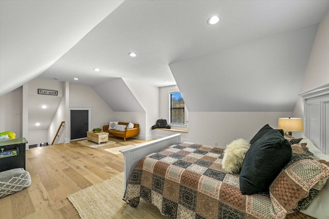 bedroom with lofted ceiling and light hardwood / wood-style flooring