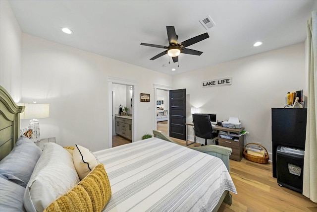 bedroom with light hardwood / wood-style floors, ensuite bathroom, and ceiling fan