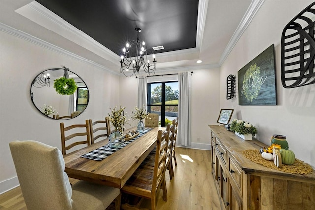 1878 Ferry Hill Rd, Dandridge, TN 37725 - dining room featuring a tray ceiling, a chandelier, light wood-style flooring, crown molding, and baseboards