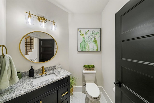 bathroom featuring toilet and vanity