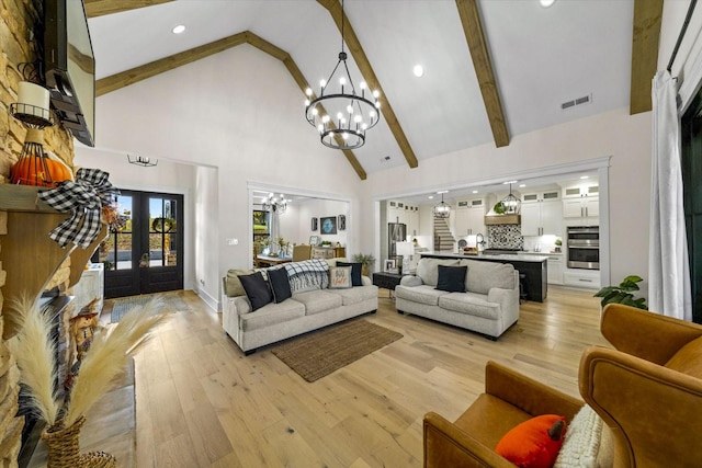1878 Ferry Hill Rd, Dandridge, TN 37725 - living area with a chandelier, high vaulted ceiling, beamed ceiling, light wood-style floors, and french doors