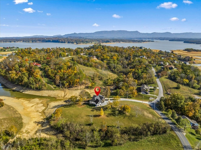 drone / aerial view featuring a water and mountain view