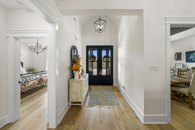 1878 Ferry Hill Rd, Dandridge, TN 37725 - foyer with a chandelier, light wood-type flooring, baseboards, french doors, and lofted ceiling