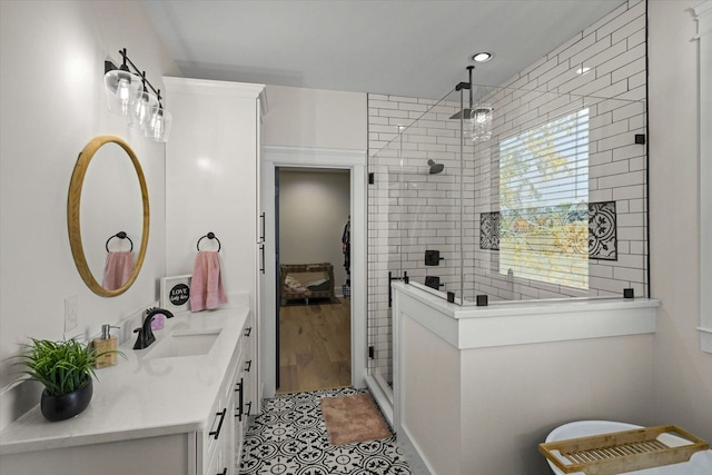 bathroom with vanity, tile patterned flooring, and an enclosed shower