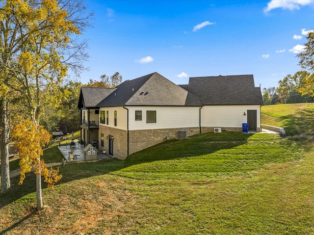 back of property featuring a yard and central AC unit